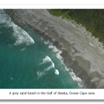 Gray-sand-beach-with-rocky-offshore-washed-by-gentle-surf-in-Alaska-Gulf-of-Alaska-Ocean-Cape-ar.png